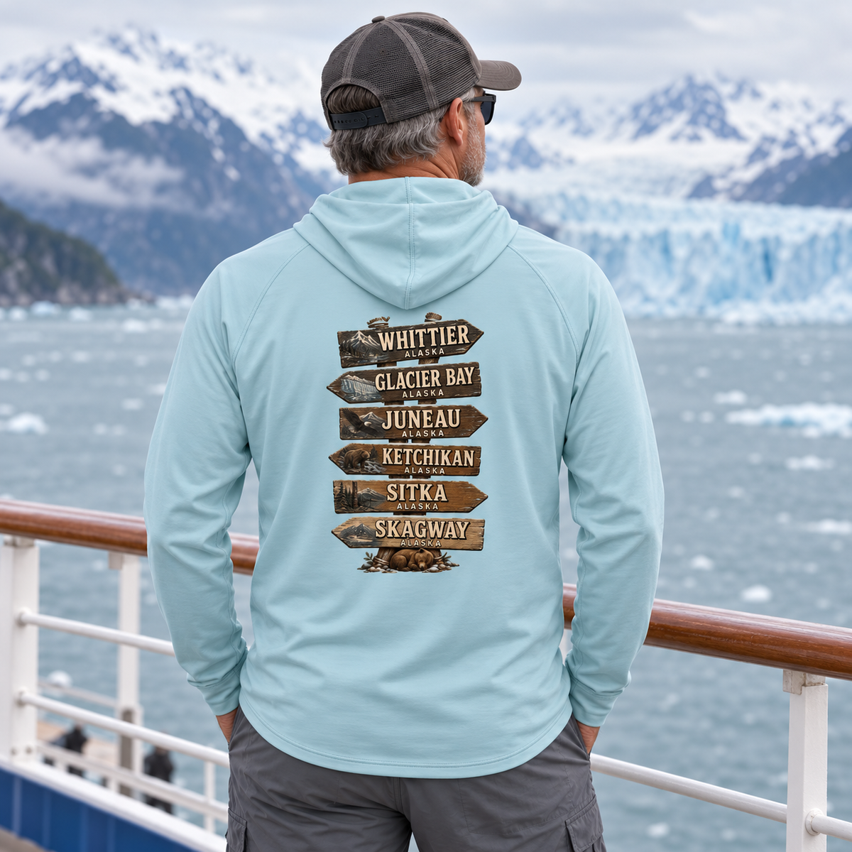 Man wearing Arctic Blue Alaska Town Sign performance hoodie, back view