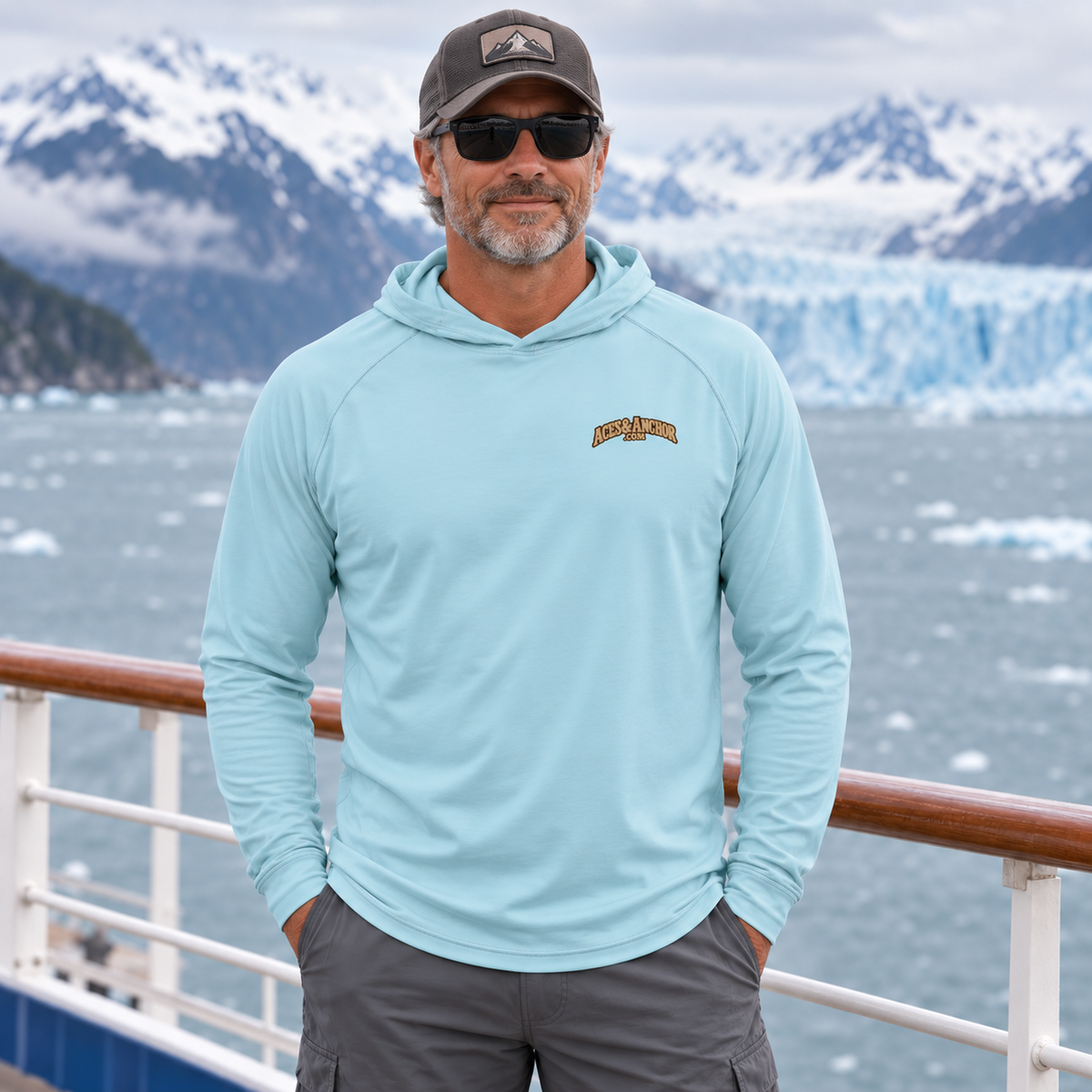 Man wearing Arctic Blue Alaska Town Sign performance hoodie, front view