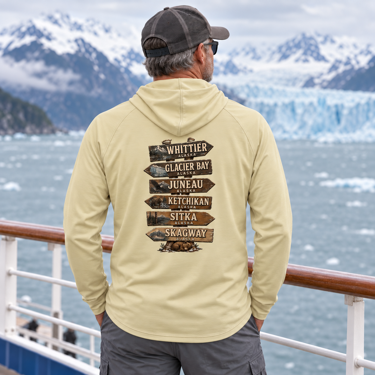 Man wearing Pale Yellow Alaska Town Sign performance hoodie, back view