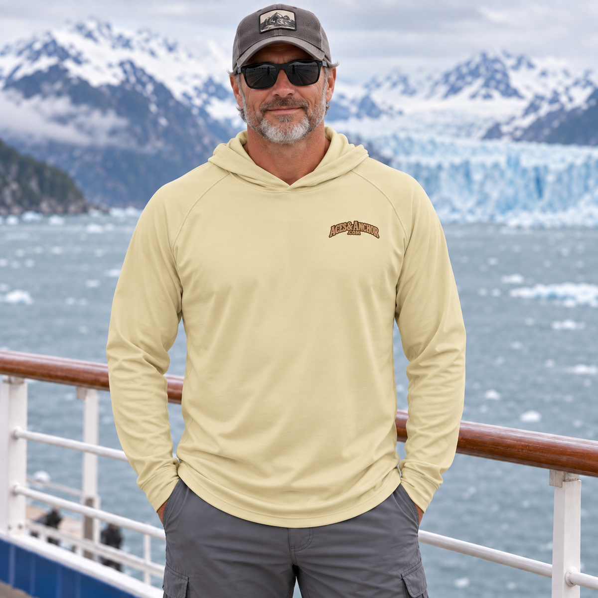 Man wearing Pale Yellow Alaska Town Sign performance hoodie, front view
