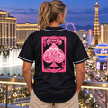 Woman wearing Aces & Anchor Pink Ace black baseball jersey, back view